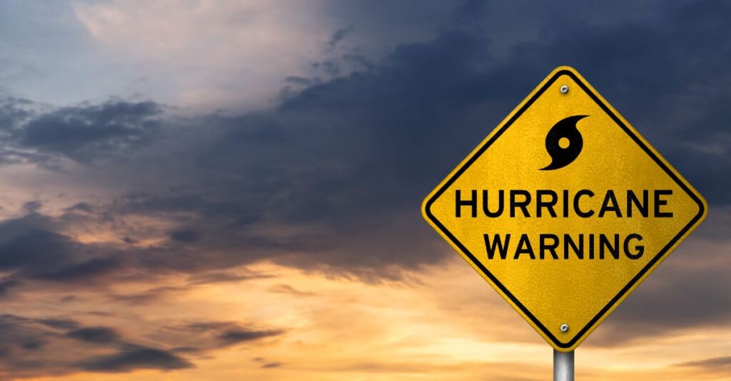 Yellow road sign signaling Hurricane Warning